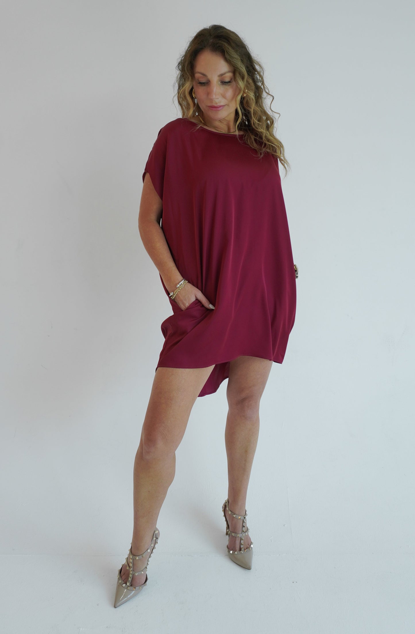 Woman wearing a burgundy dress on a white background